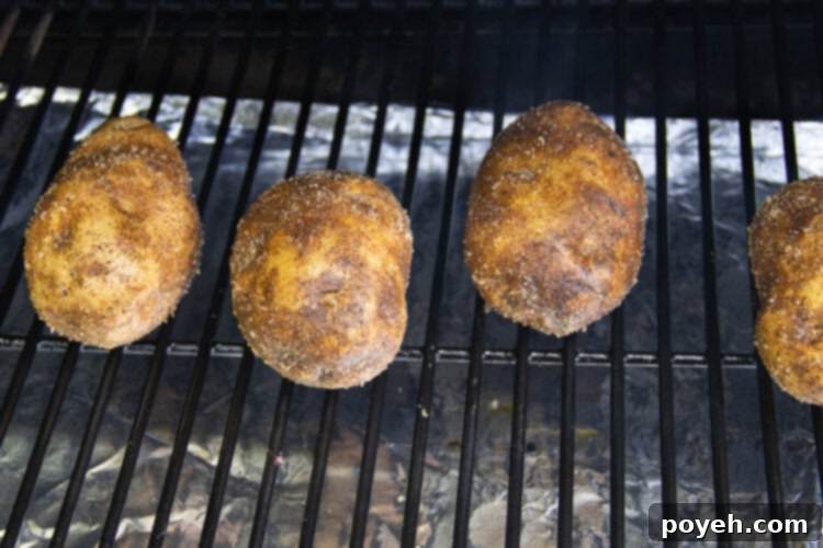 Potatoes on a smoker grate.