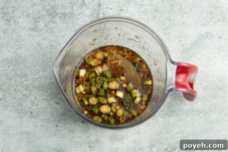 Adobo marinade in a glass mixing cup.