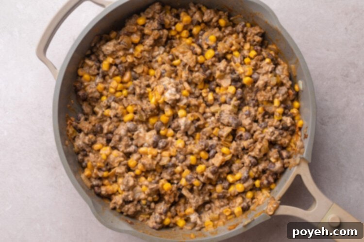 Walking taco casserole filling in a large skillet.