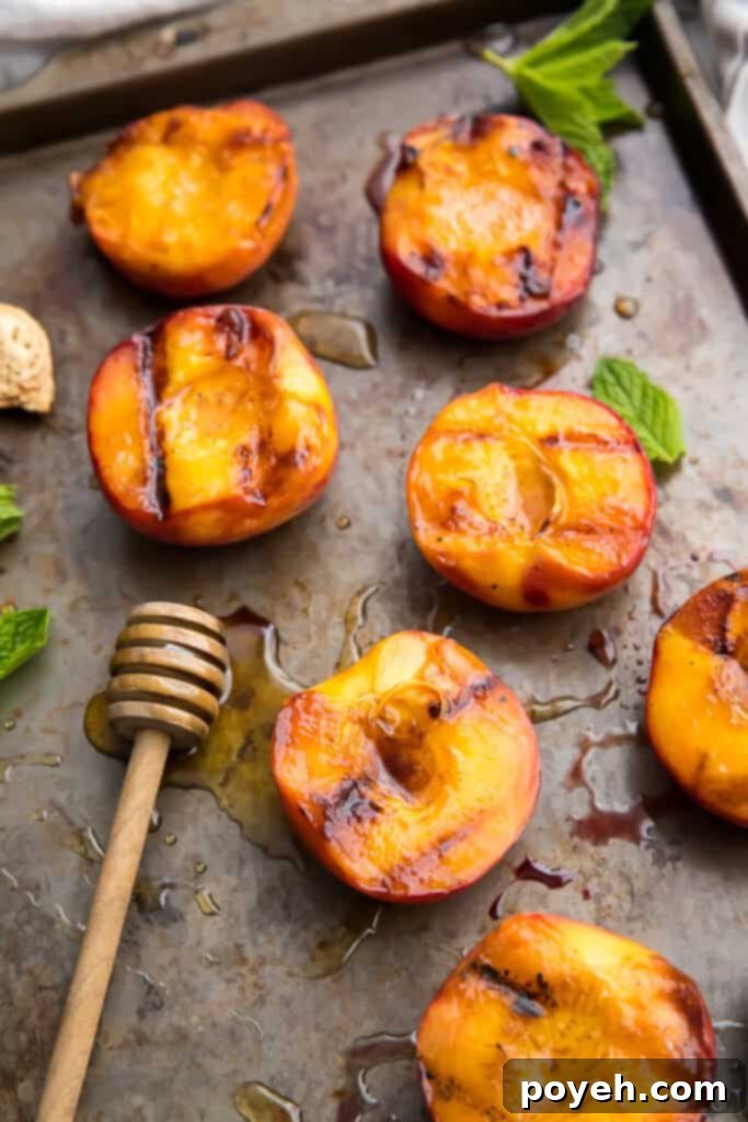 Grilled peaches on a baking sheet, ready to be served