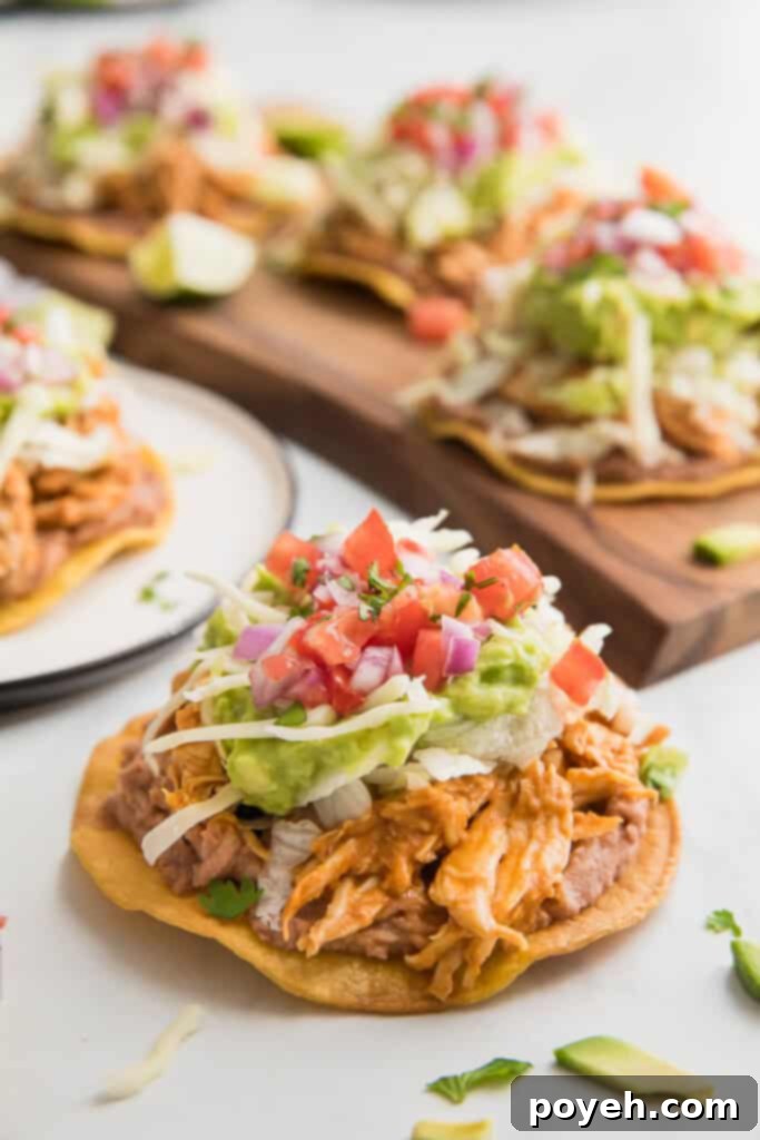 A loaded chicken tostada, ready to be enjoyed