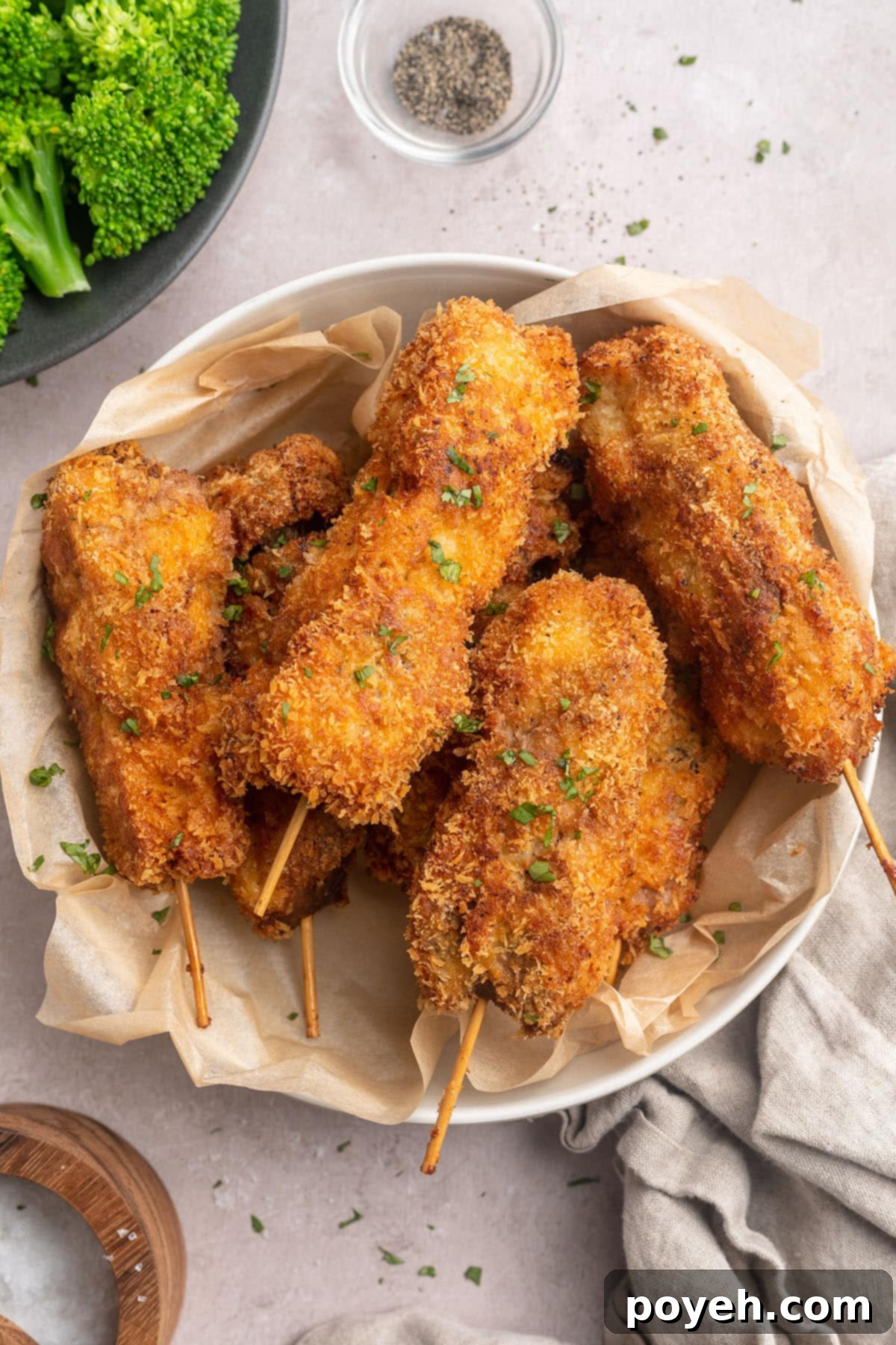 Mock chicken legs on a plate with broccoli and potatoes, ready for a meal.