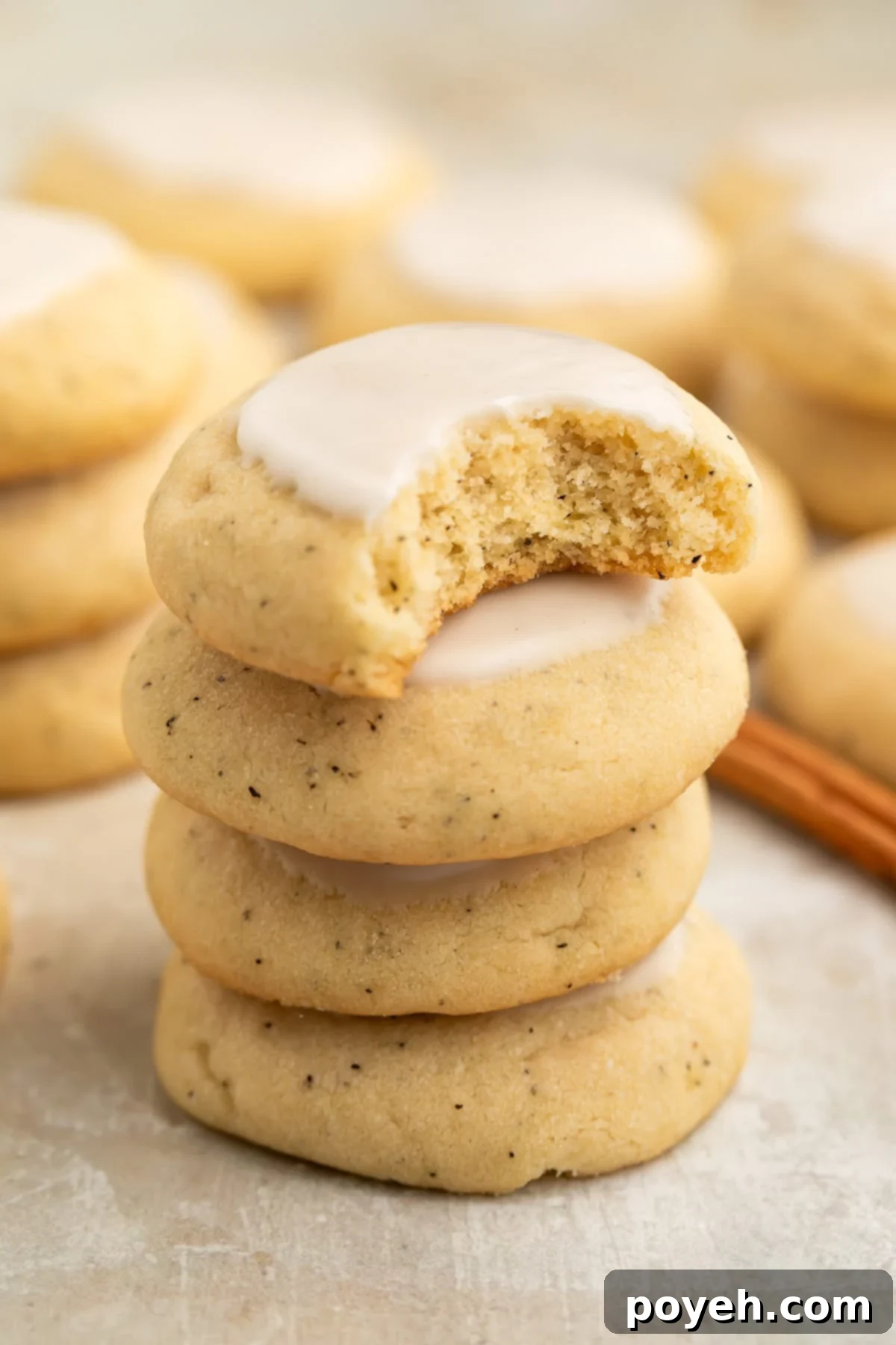 Four chai cookies, inspired by Taylor Swift's famous recipe, artfully stacked on top of each other. The topmost cookie has a bite missing, revealing its soft, spiced interior.