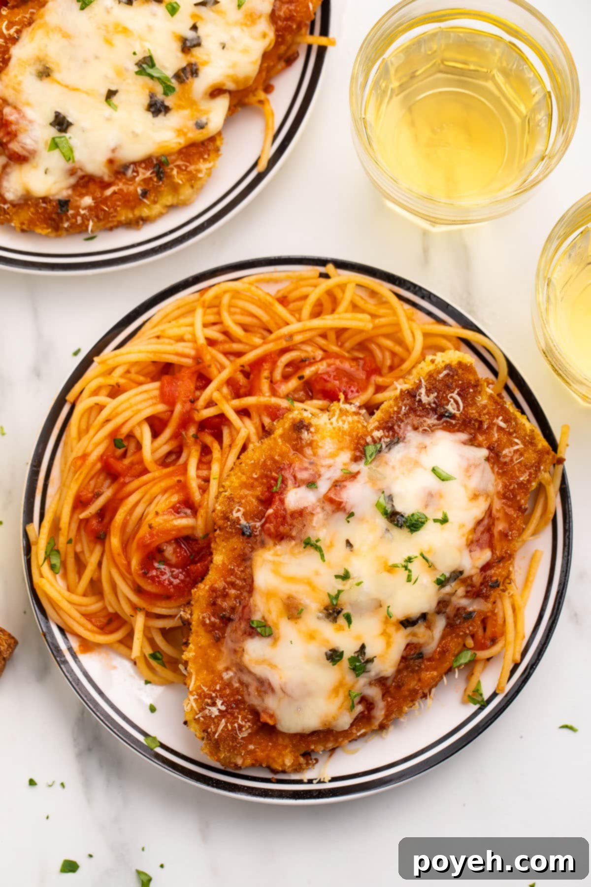 Close-up of gluten-free chicken parmesan showing the melted cheese and crispy breading.