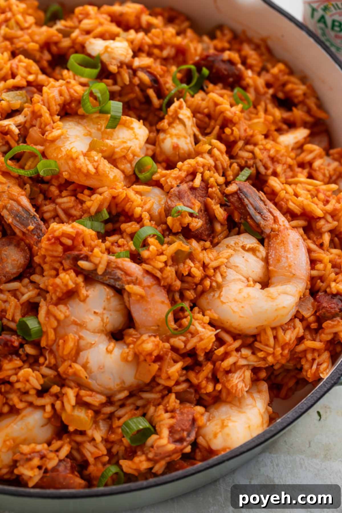 Cajun Seafood Fiesta 3 A large Dutch oven holding rich, vibrant seafood jambalaya made with luscious shrimp and tender rice, ready to be served.