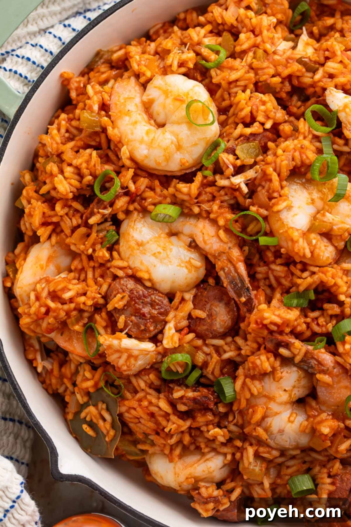 Cajun Seafood Fiesta 4 Close-up of seafood jambalaya ingredients, showing cooked shrimp, andouille sausage, and rice.