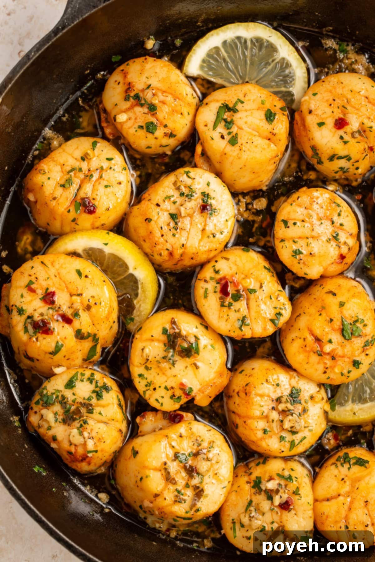 Smoked Scallops with a lemon, garlic and herb butter in a cast iron skillet.