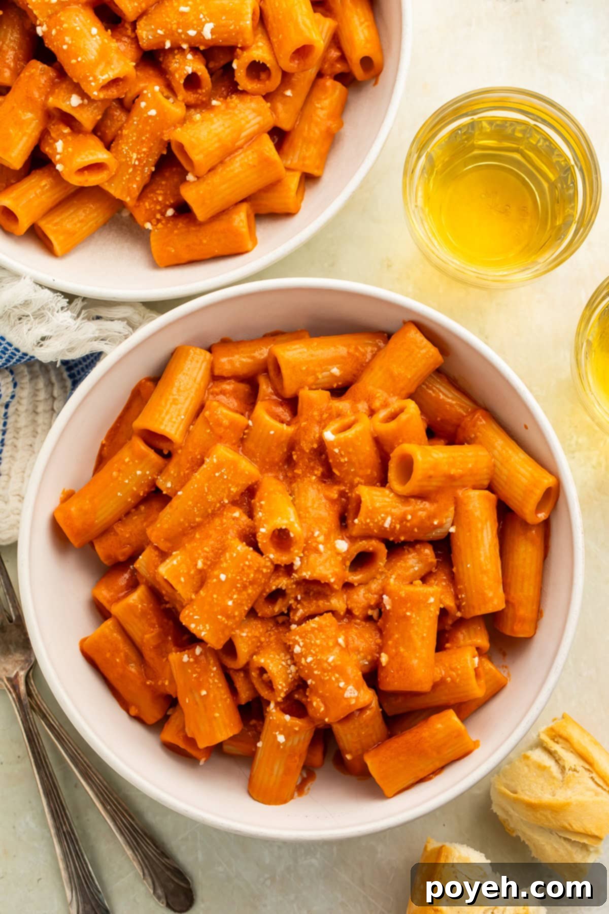 Two white bowls of rigatoni alla vodka.