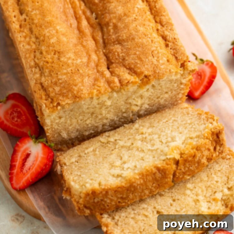 Top down picture of a sliced pound cake on a wooden board.