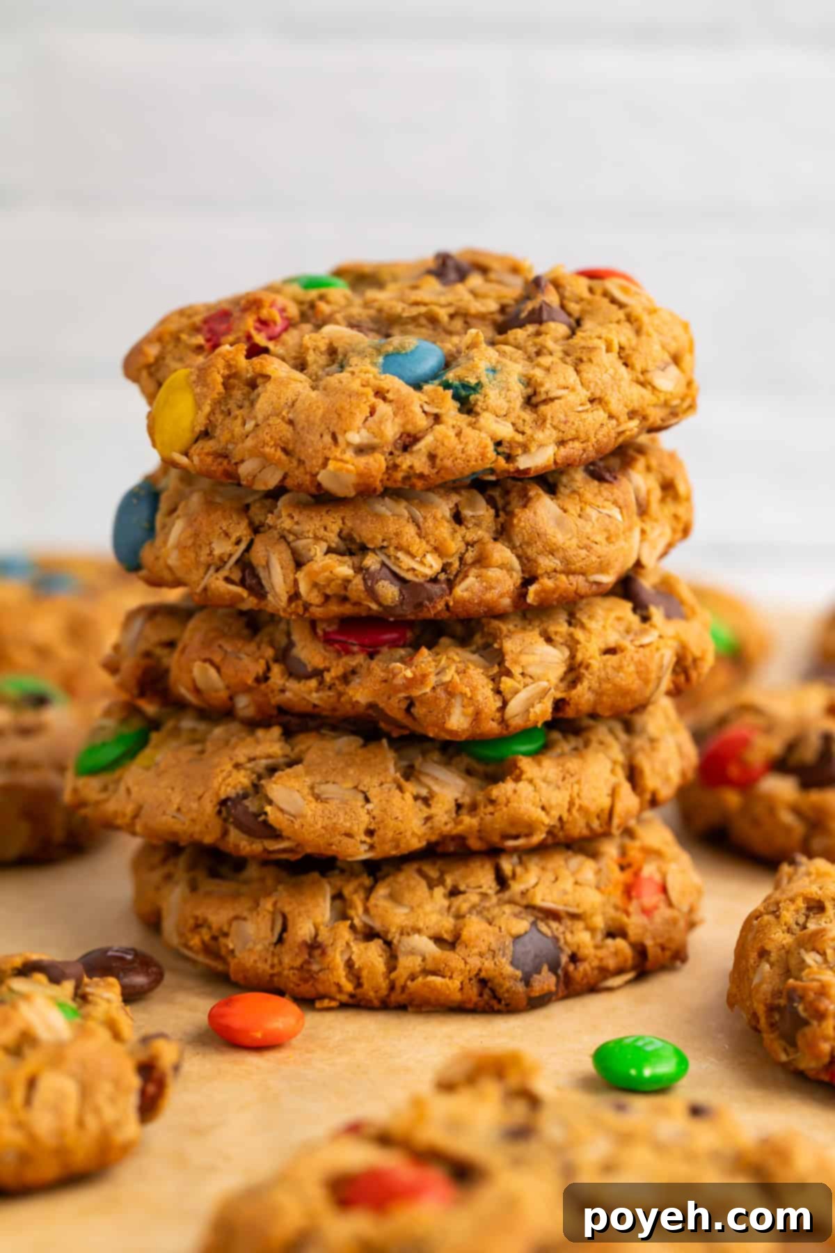 A perfectly baked, thick Gluten-Free Monster Cookie, showcasing its chewy texture, chocolate chips, and vibrant M&M candies.
