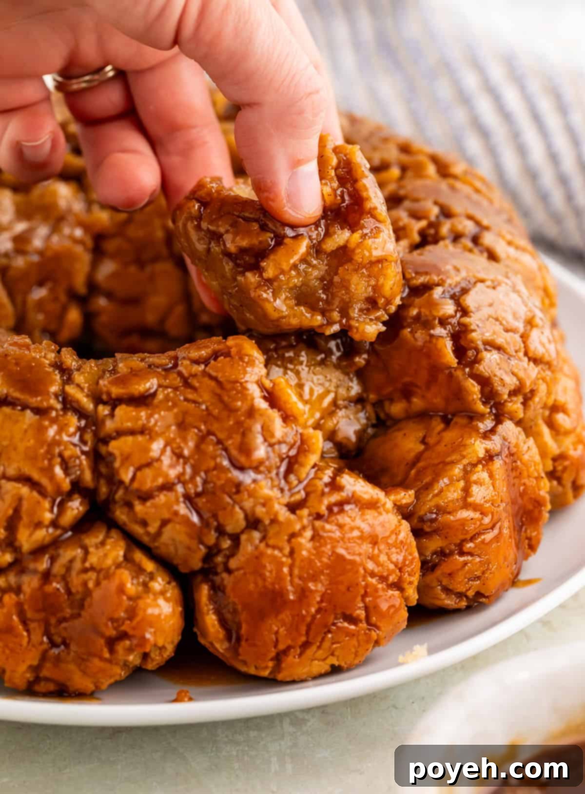 Gooey Gluten-Free Monkey Bread Bliss 4 hand removing a piece of gluten-free monkey bread.