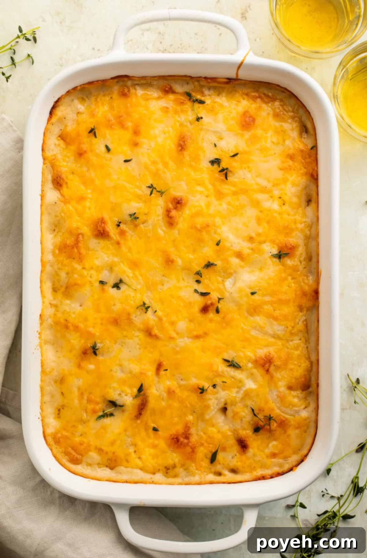 Gluten free scalloped potatoes pictured in a white baking dish.