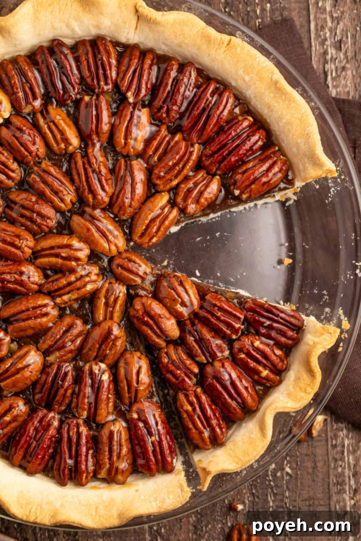 Top down photo of a vegan pecan pie with a slice missing.