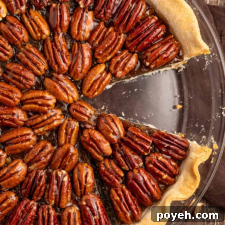 Top down photo of a vegan pecan pie with a slice missing.