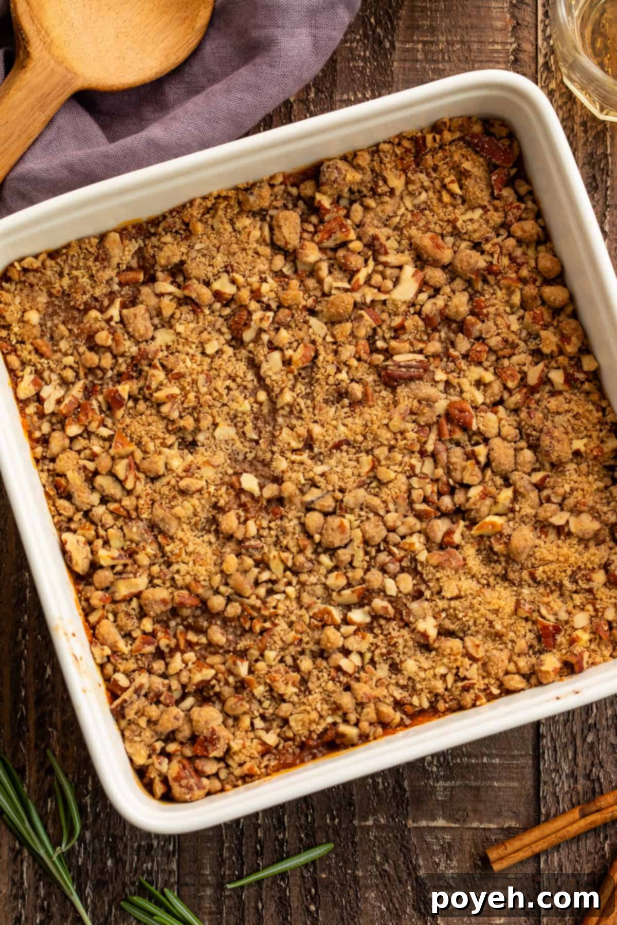 Overhead shot of a white square dish filled with a crunchy-topped sweet potato casserole.