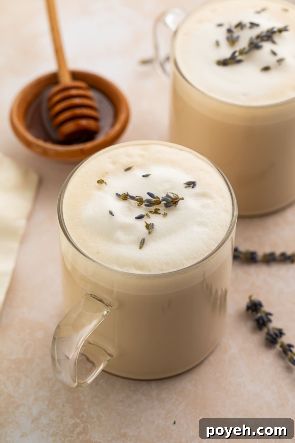 A close-up of a London fog latte with foamed milk and a tea bag.