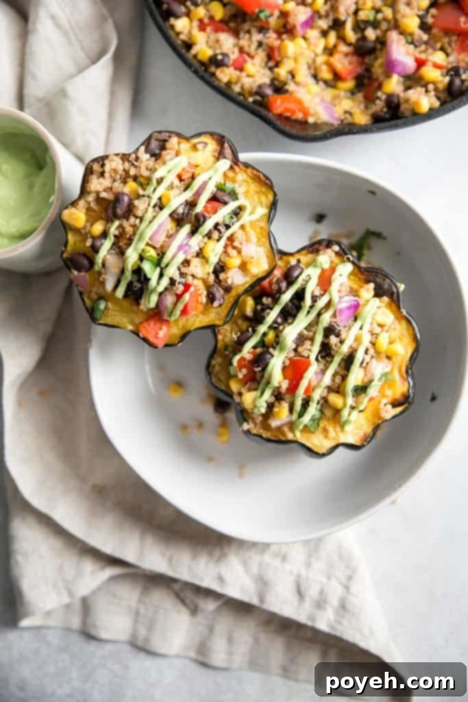 An inviting overhead shot of Mexican stuffed acorn squash halves, generously filled with a vibrant mixture of quinoa, corn, black beans, and colorful bell peppers.