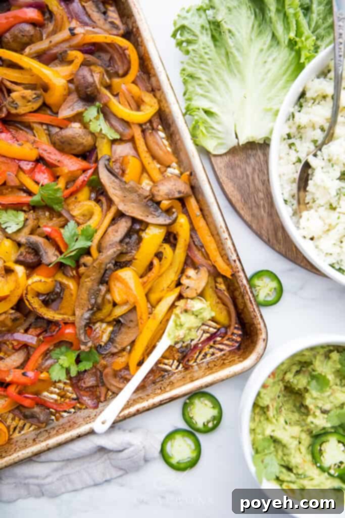 Colorful sheet pan vegetarian fajitas featuring vibrant bell peppers, sliced onions, and seasoned plant-based protein, perfectly roasted for tacos or burritos.