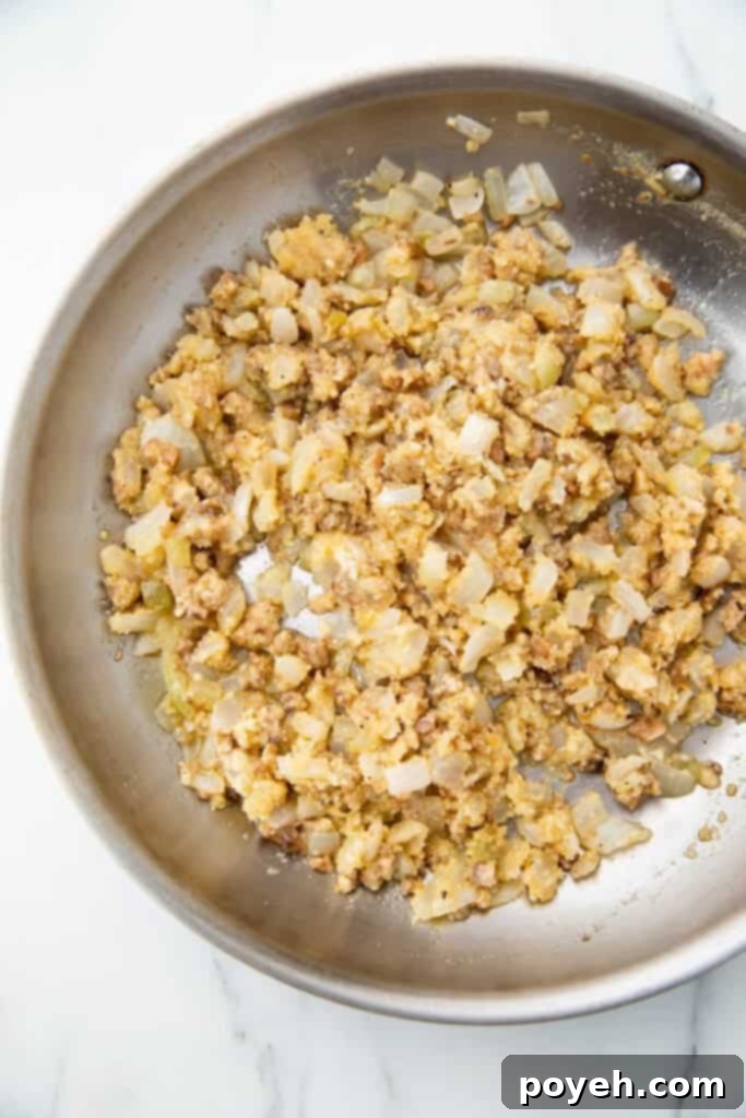 Wholesome Stuffed Mushroom Bites 3 Close-up of the savory stuffing mixture for vegetarian stuffed mushrooms in a skillet, showcasing its thick consistency.