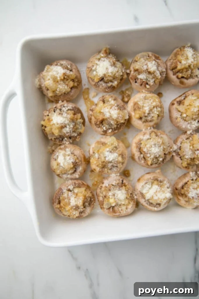 Wholesome Stuffed Mushroom Bites 4 Stuffed mushrooms arranged neatly in a baking dish, ready for the oven.