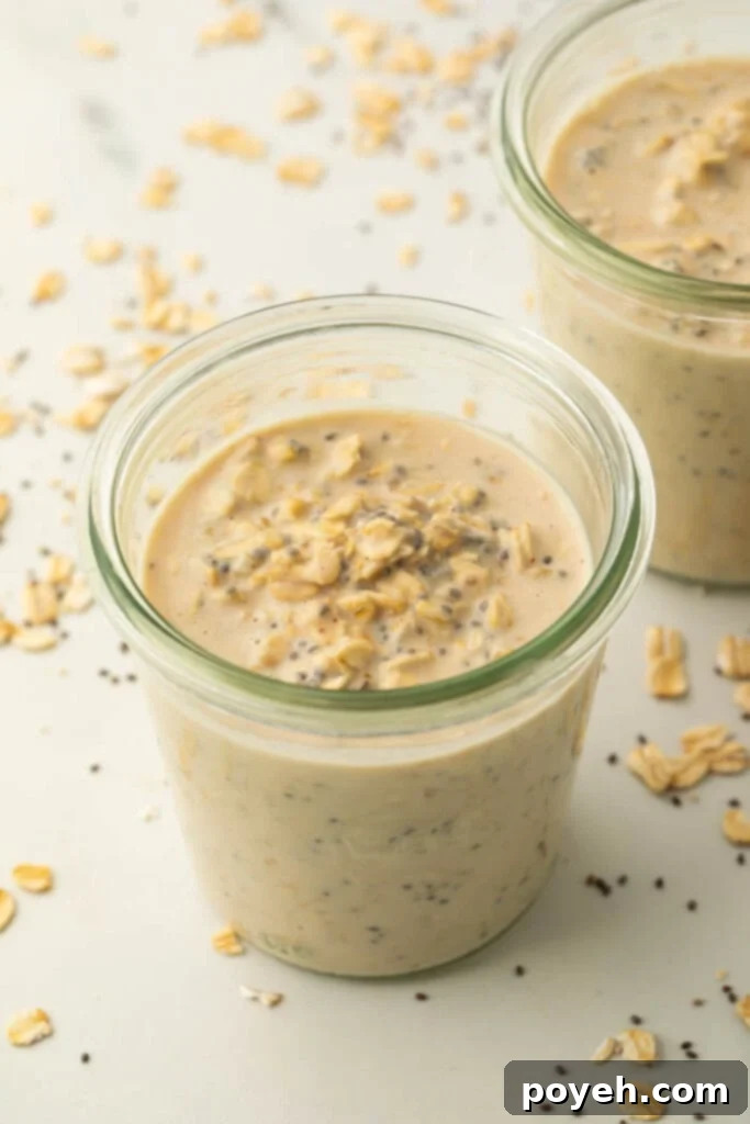 Mason jar with mixed overnight oats, ready for chilling.