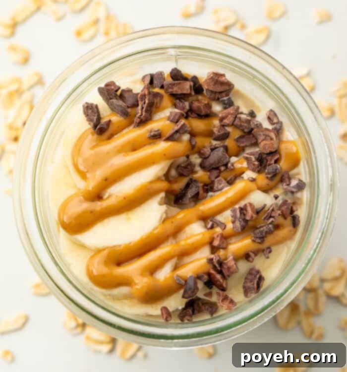 A beautifully presented mason jar of creamy Peanut Butter Overnight Oats, ready to eat.