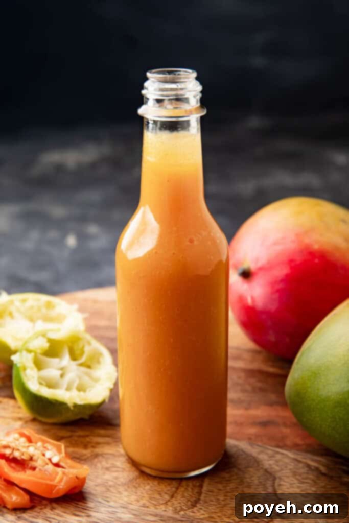 A beautifully presented jar of homemade mango habanero sauce, highlighting its vibrant color and smooth texture. Ideal for spicy and fruity flavor lovers.
