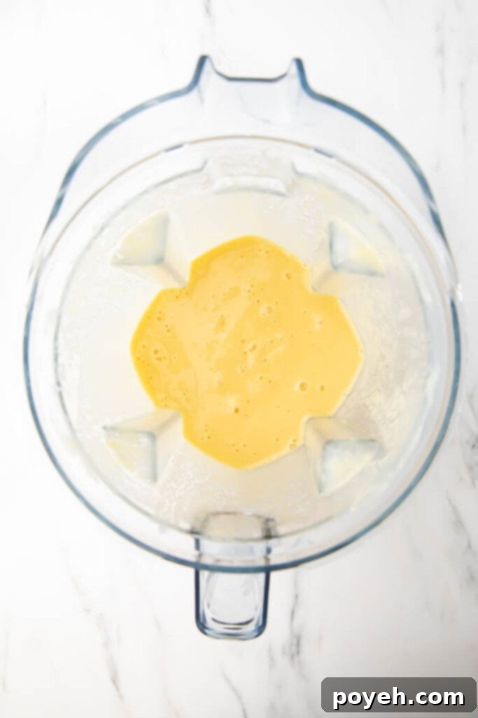 Blended mango pineapple smoothie in a blender