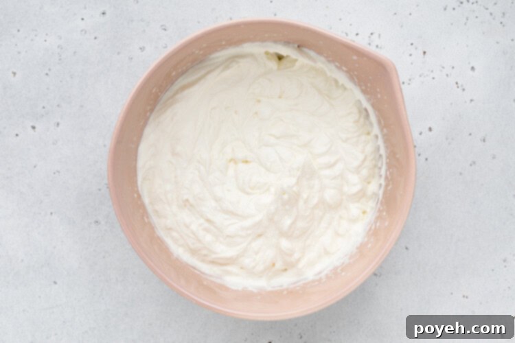 keto whipped cream forming stiff peaks in a bowl