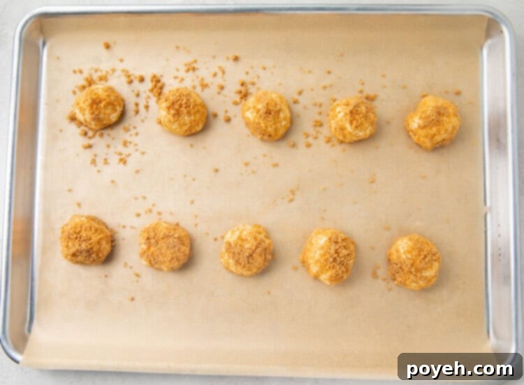Cream cheese fat bombs lined on a baking sheet to freeze