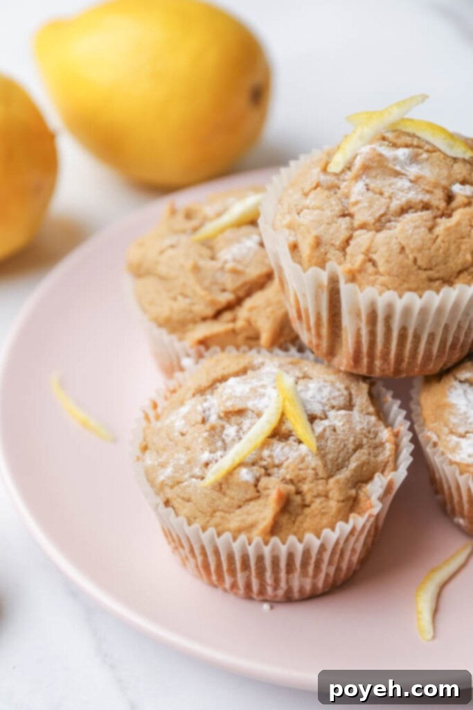 An artistic arrangement of golden-baked lemon ricotta muffins on a chic pink plate, ready for presentation.