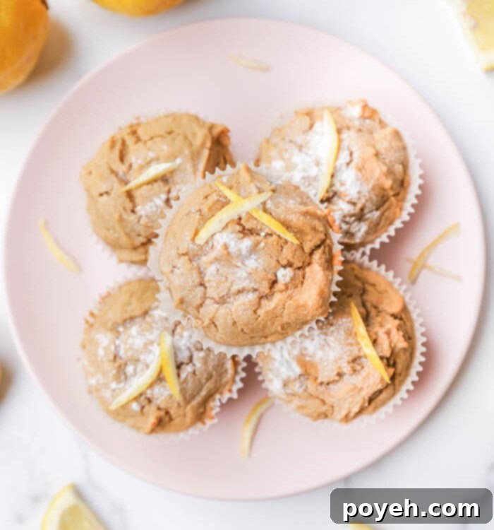 A freshly baked healthy lemon muffin, showcasing its golden crust and soft interior, ready for a taste.