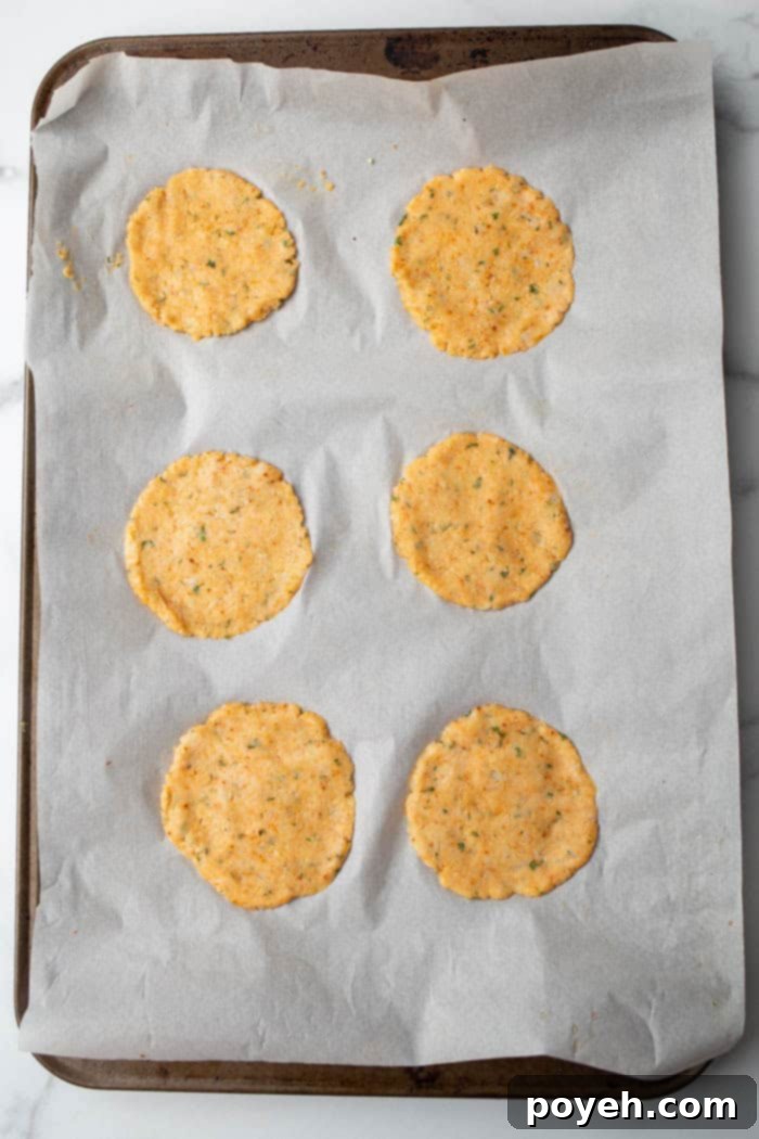 Cauliflower chips being shaped and placed on a baking sheet, ready to be baked until golden and crispy.