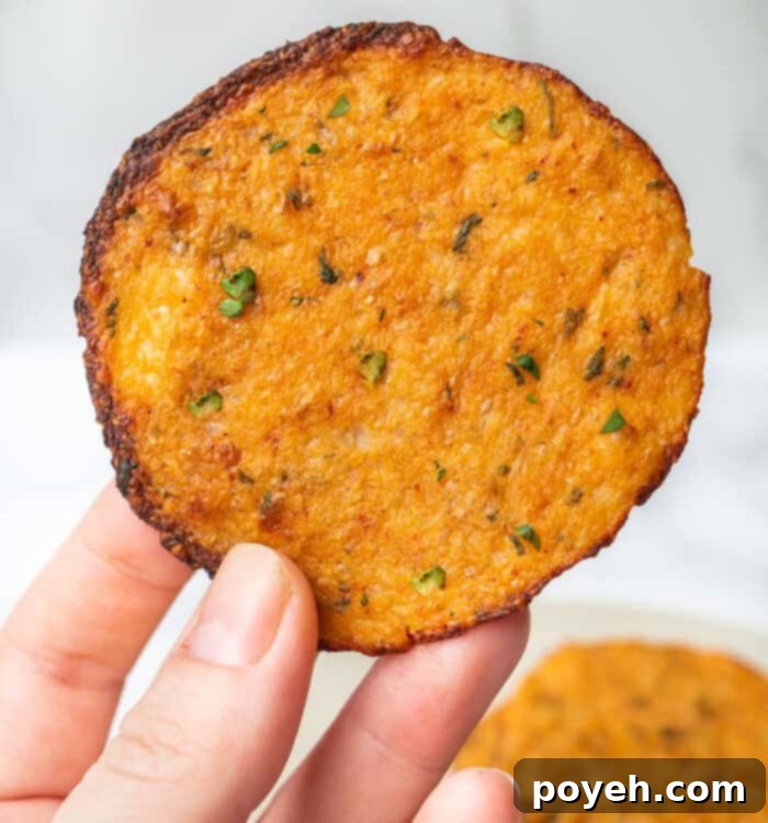 Close-up of baked cauliflower chips on a wire rack, cooling and showcasing their golden-brown color and texture.