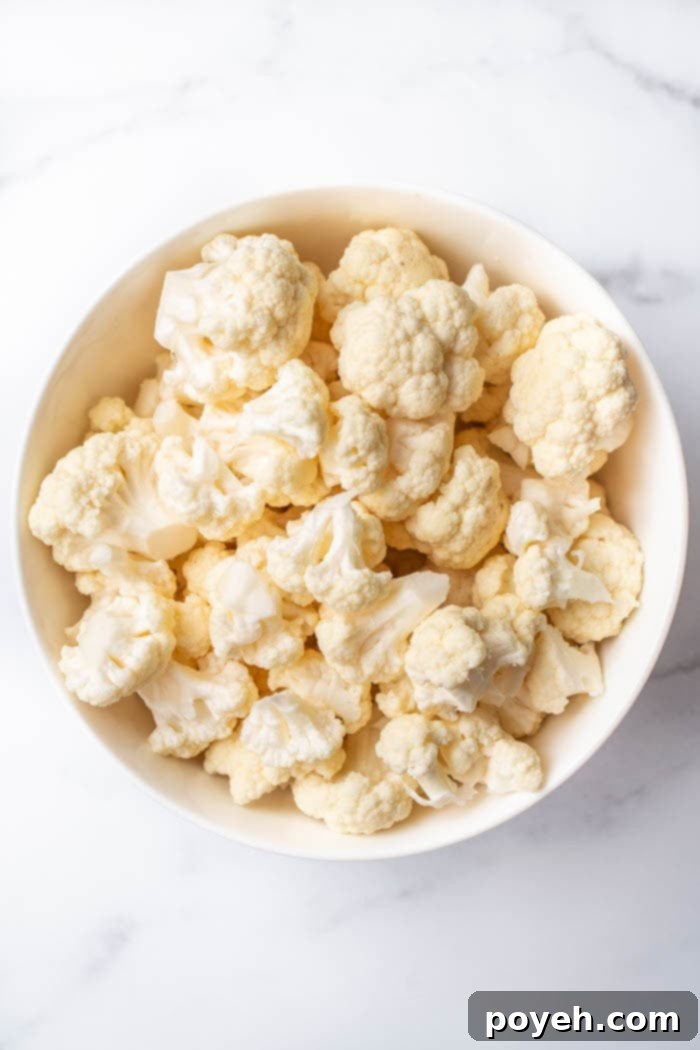 Cauliflower florets being steamed in a pot, ready for the next step of making healthy chips.