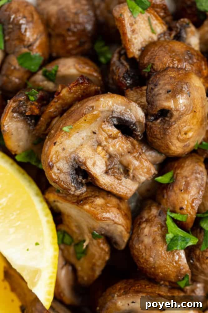 close up image of air fryer mushrooms topped with fresh parsley