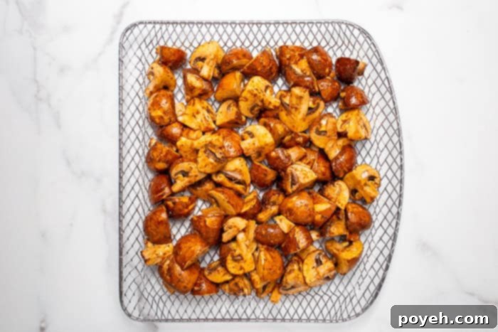 Marinated mushrooms resting on a air fryer tray
