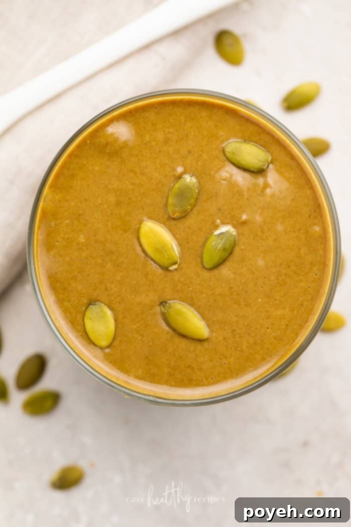 Overhead shot of pumpkin seed butter garnished with roasted seeds