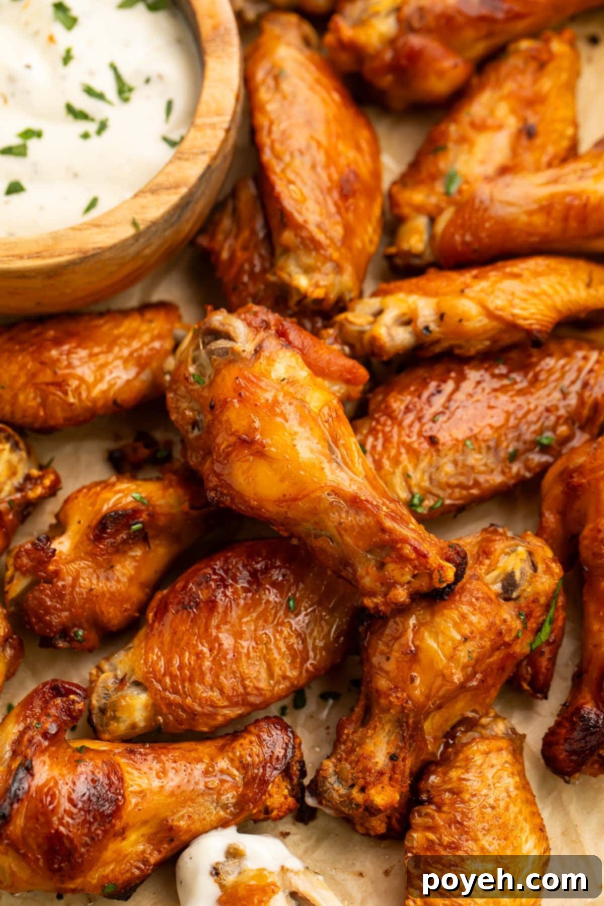 A vibrant spread of perfectly brined chicken wings, golden-brown and crispy, arranged on a sheet pan with a small bowl of creamy ranch dressing for dipping, ready for a game day feast.