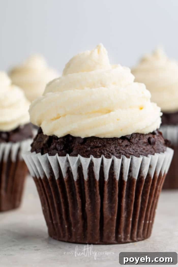 A perfectly frosted chocolate keto cupcake topped with smooth cream cheese icing, ready to be enjoyed.