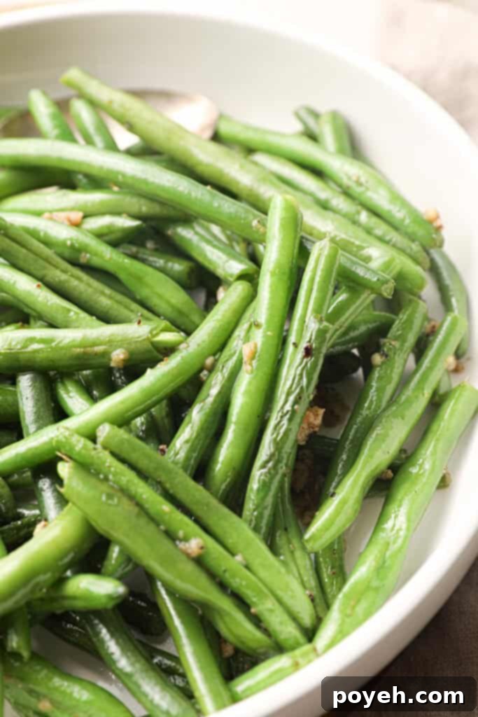 Overhead shot of keto green beans in a white bowl