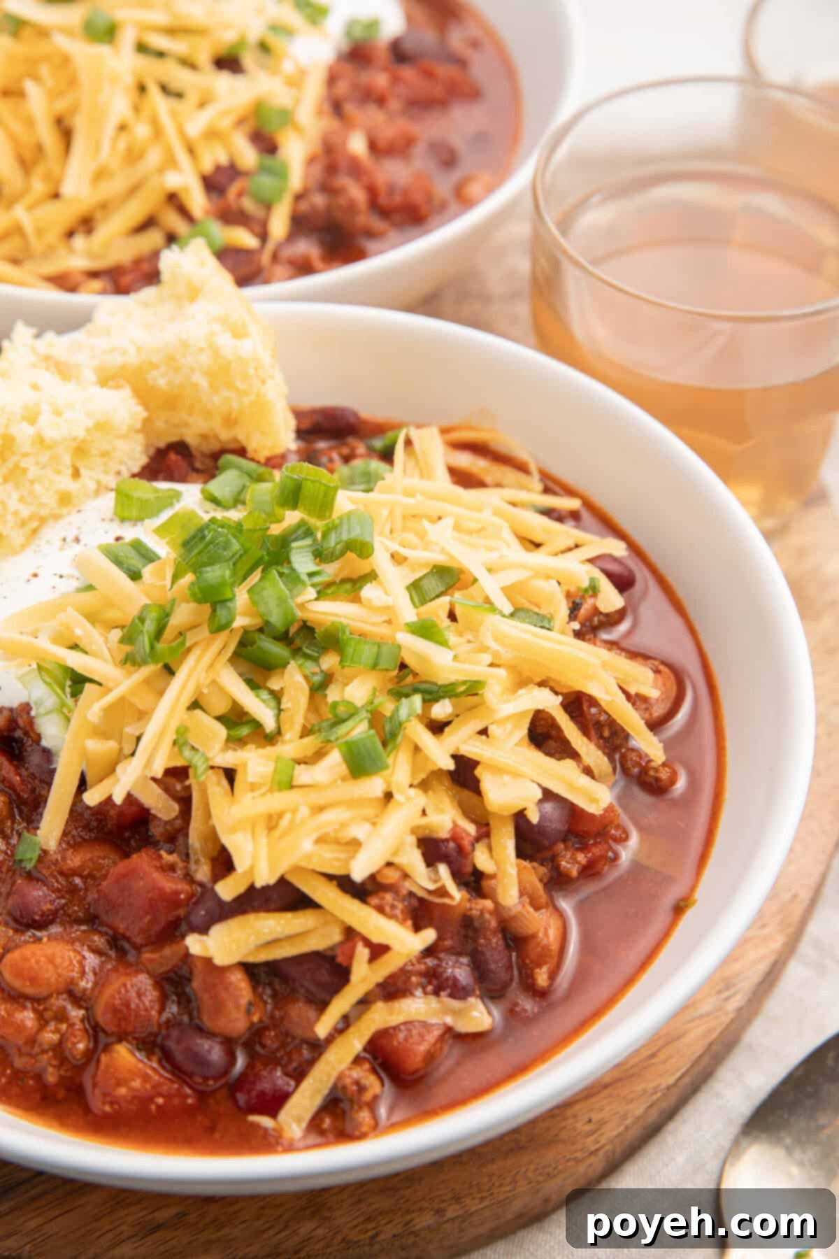 Two bowls of bison chili topped with cheese