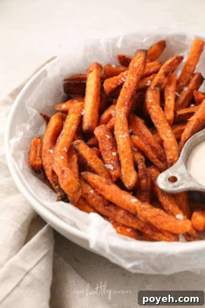 Sweet potato fries with salt in a white bowl