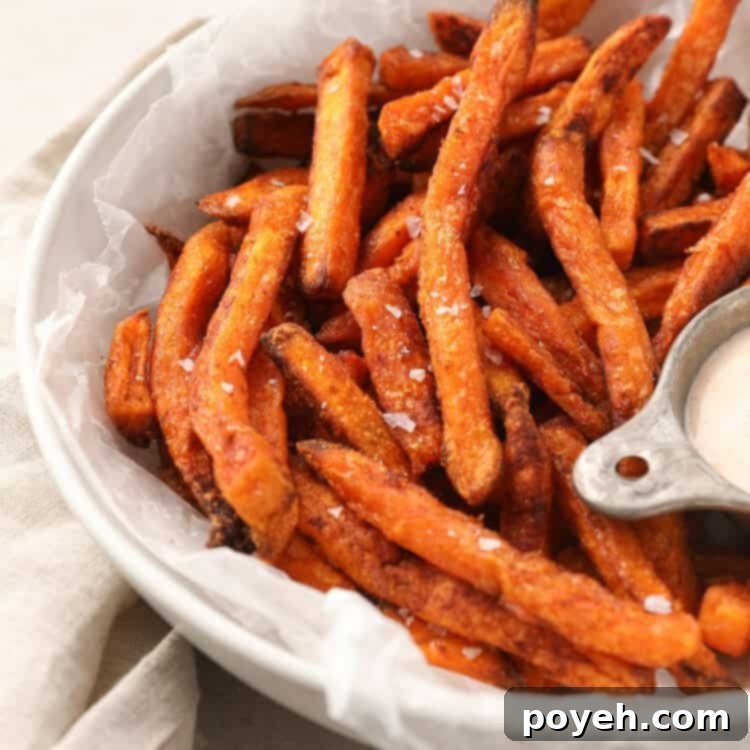 Sweet potato fries with salt in a white bowl