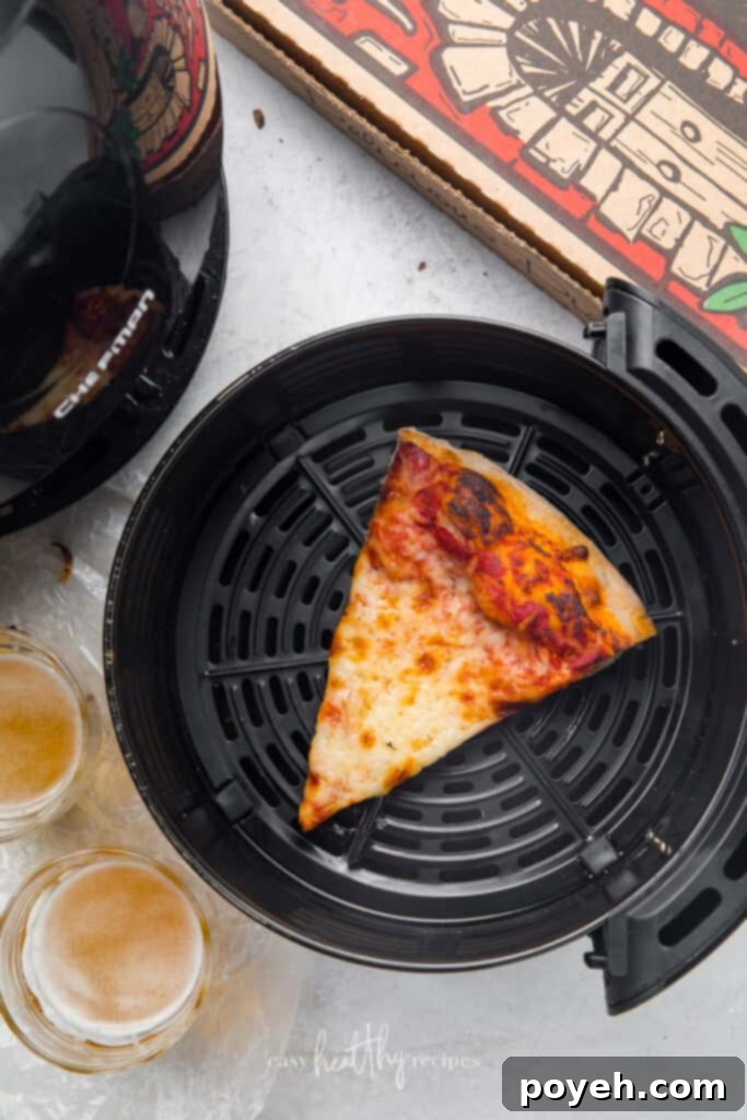 One slice of cheese pizza in an air fryer bowl