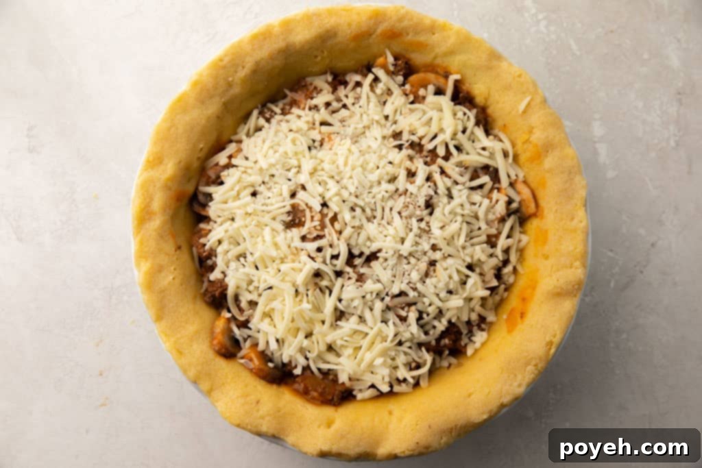 Uncooked whole keto meat pie in a keto pie crust