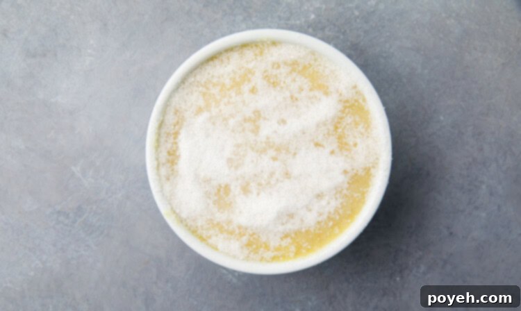 Liquid vegan crème brûlée mixture poured into a small ramekin, ready to be chilled.