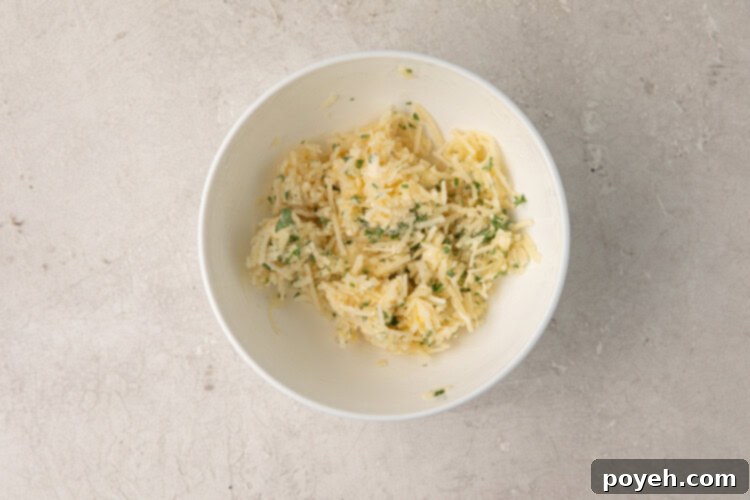 Butter, garlic, parsley, and parmesan in a bowl for garlic bread