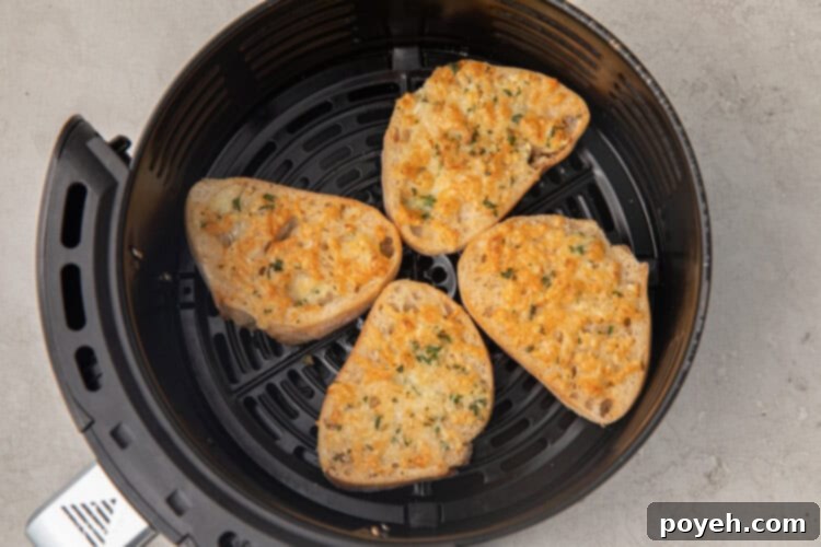Air fryer garlic bread slices in the basket of an air fryer