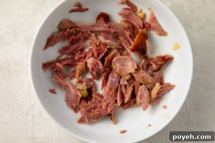 Prepared smoked turkey meat, shredded and ready to be added to the soup.